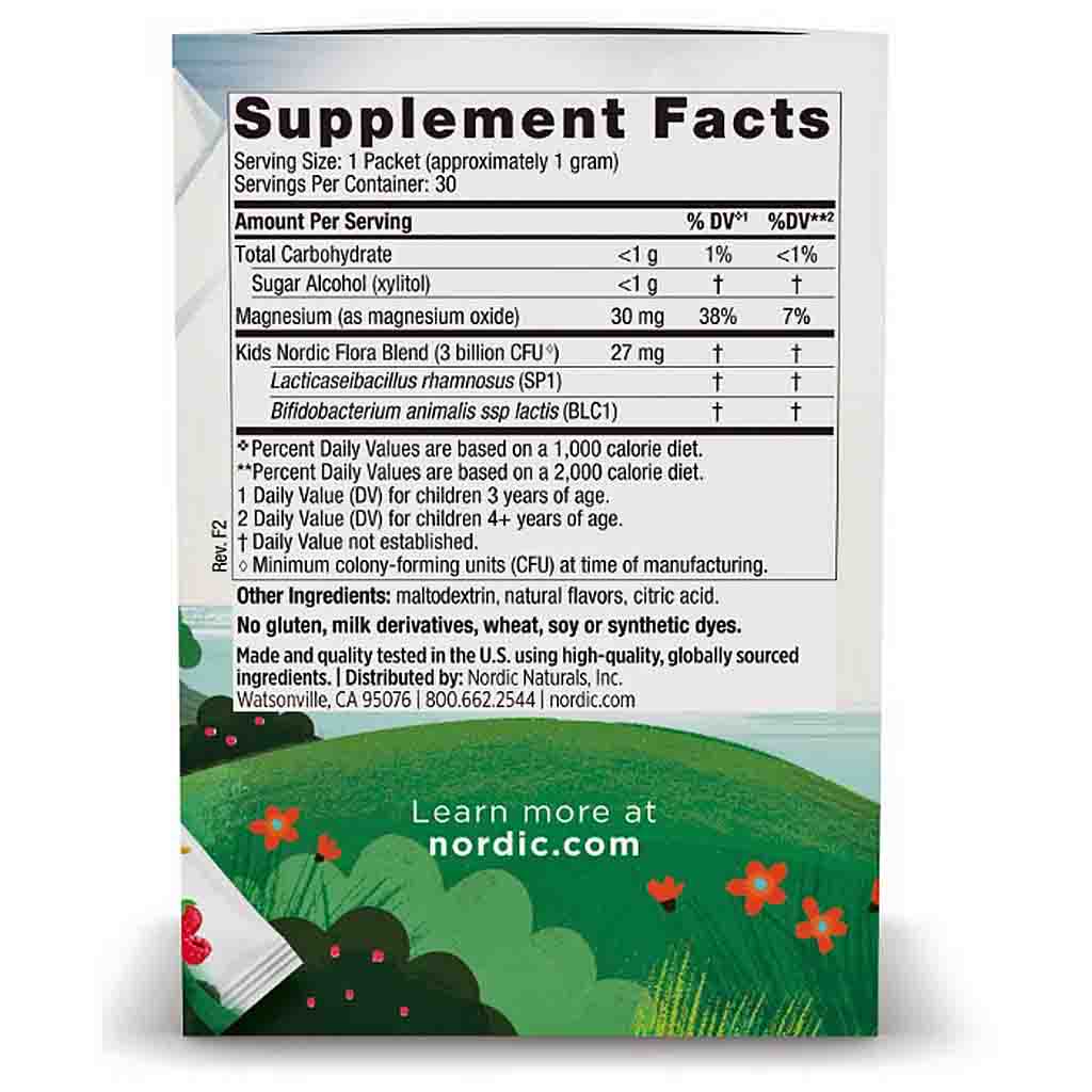 The back of a Nordic Naturals Kids Nordic Flora Blend supplement packet, showing the Supplement Facts panel with nutritional information, set against a background of a green field with flowers and an open book.