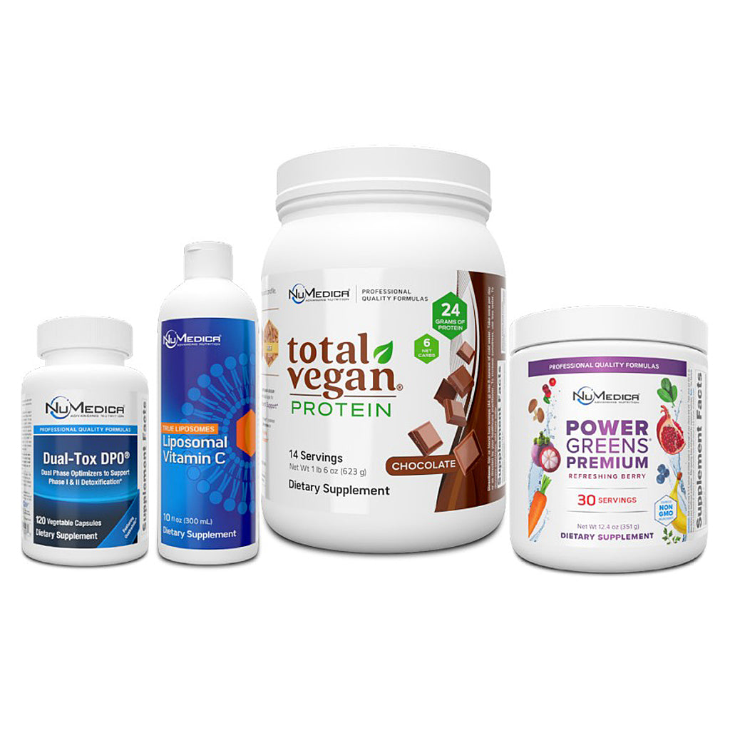 Four white supplement containers from NuMedix arranged on a white background: a small Dual-Tox DPD+ bottle, a Liposomal Vitamin C bottle, a large Total Vegan Protein tub in chocolate flavor, and a Power Greens Premium powder tub.