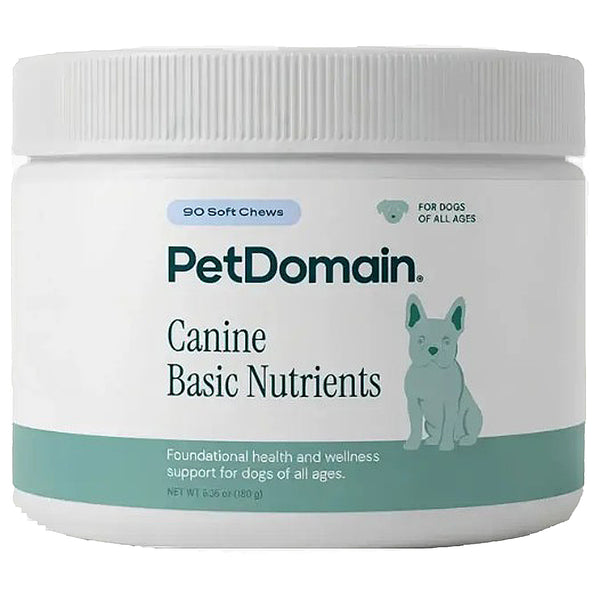 A white plastic jar of PetDomain Canine Basic Nutrients soft chews for dogs, featuring a white lid and a label with teal accents and a dog illustration.