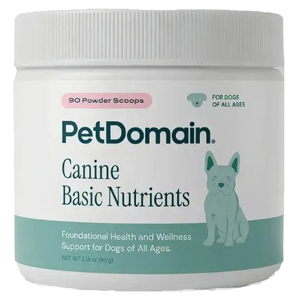 A white plastic jar of PetDomain Canine Basic Nutrients with a white screw-top lid, featuring a label with teal and pink text and a light teal dog illustration.