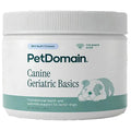 A white plastic jar of PetDomain Canine Geriatric Basics soft chews for senior dogs, featuring a teal and white label with a puppy illustration.