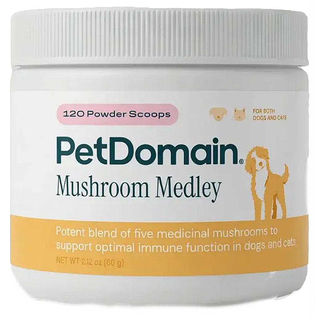A white plastic jar of PetDomain Mushroom Medley for dogs and cats, containing 120 powder scoops. The label features the brand name in dark teal, a pink badge, and an orange-yellow band at the bottom with a cartoon dog illustration.