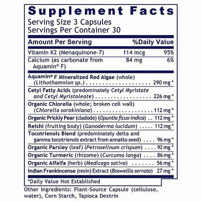 A close-up of a supplement facts label showing a supplement bottle's nutrition panel. The label lists ingredients such as Vitamin K2, Calcium, Aquamin F, and various organic chlorella and parsley extracts, with percentages of daily value and a note that daily value not established is marked with an asterisk.