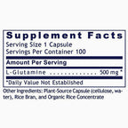 A close-up of a supplement facts label showing serving size 1 capsule, 100 servings per container, L-Glutamine 500 mg, and other ingredients including plant-source capsule, rice bran, and organic rice concentrate.
