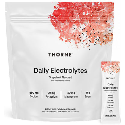 A white stand-up pouch of Thorne Daily Electrolytes grapefruit flavored dietary supplement, shown with a smaller matching single-serve stick pack beside it on a white background.
