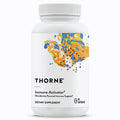 A white plastic bottle of Thorne Immune Activator dietary supplement with a white cap, featuring a colorful abstract label with blue, orange, and yellow paint splatters and black text.